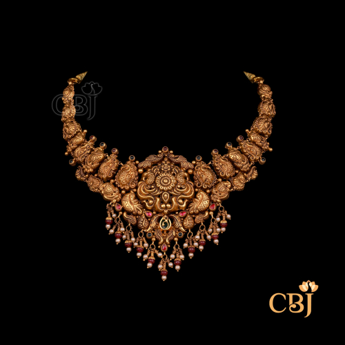 18 grams antique Nakshi short gold necklace with traditional artwork, antique gold finish, and a compact structured form.