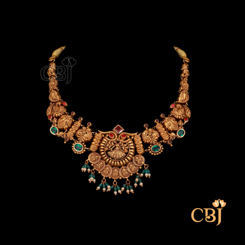 19 grams antique Nakshi short gold necklace with bold handcrafted motifs, textured antique finish, and compact traditional styling.