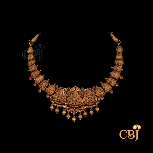 13 grams Nakshi short gold necklace with antique tone, featuring detailed traditional impressions and a close-fitting neckline style.