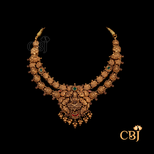 23 grams antique Nakshi short gold necklace featuring detailed carved patterns, antique gold tone, and a close-fitting neckline style.