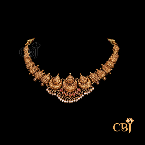 9 grams antique lightweight Nakshi Necklace shown as a delicate gold necklace with carved Nakshi detailing, antique texture, and a close neckline fit.