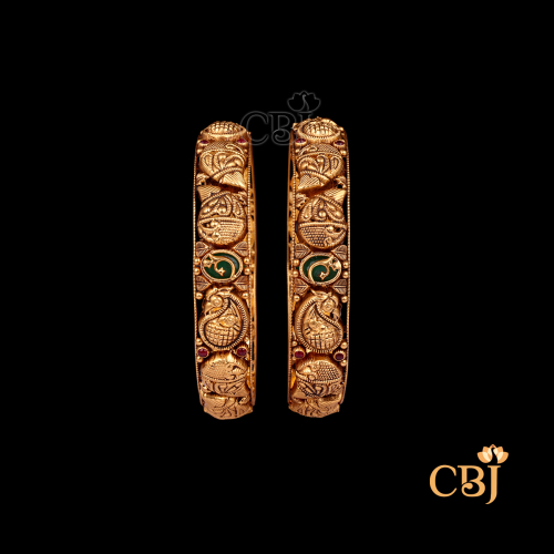 26 grams Nakshi Antique Bangles shown as a pair of gold bangles with intricate Nakshi carvings, antique finish, and circular wrist design.