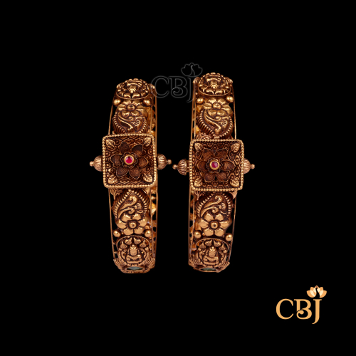 38 grams Nakshi Antique Bangles shown as a pair of traditional gold bangles with intricate Nakshi carvings, antique finish, and rounded wrist shape.