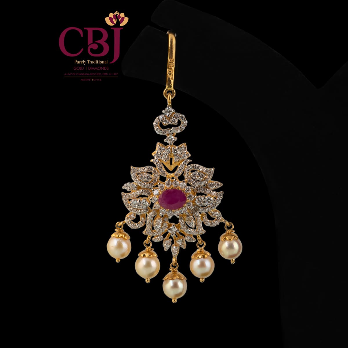 Traditional maang tikka adorned with ruby