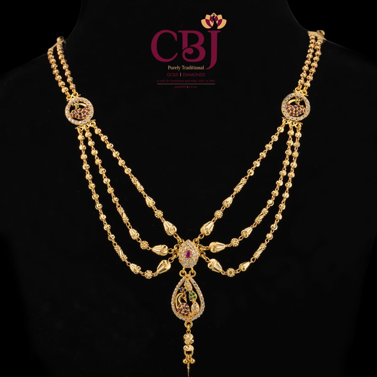 Traditional 3 line ball chain necklace with 2 side pendants and a centrepiece.
