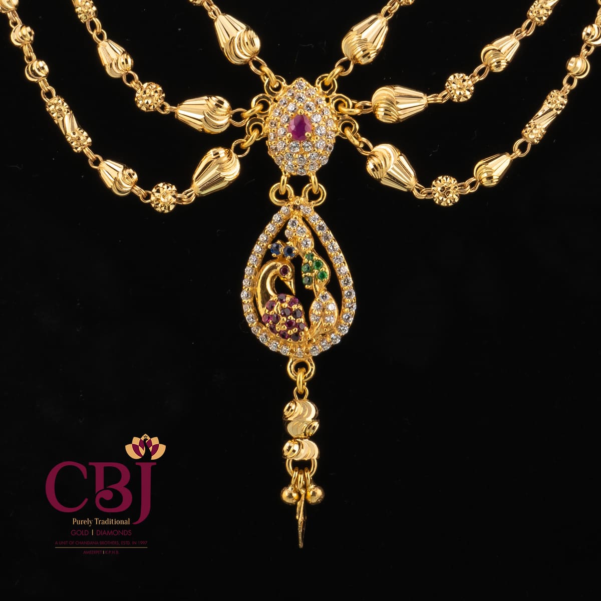 Traditional 3 line ball chain necklace with 2 side pendants and a centrepiece.