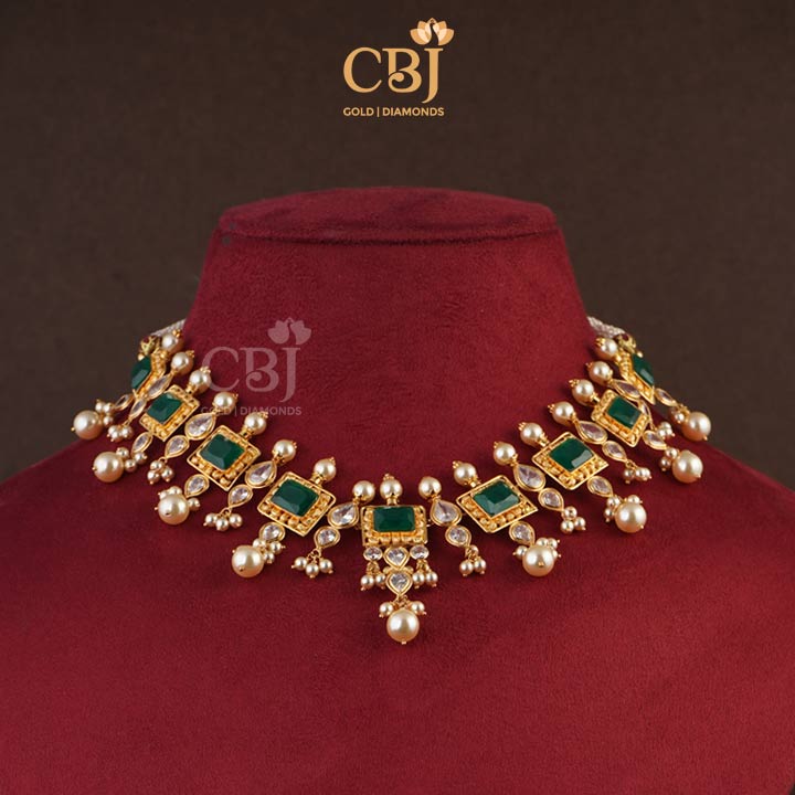This sleek ultra light weight designer short necklace highlights the subtle greens of the emerald stones.