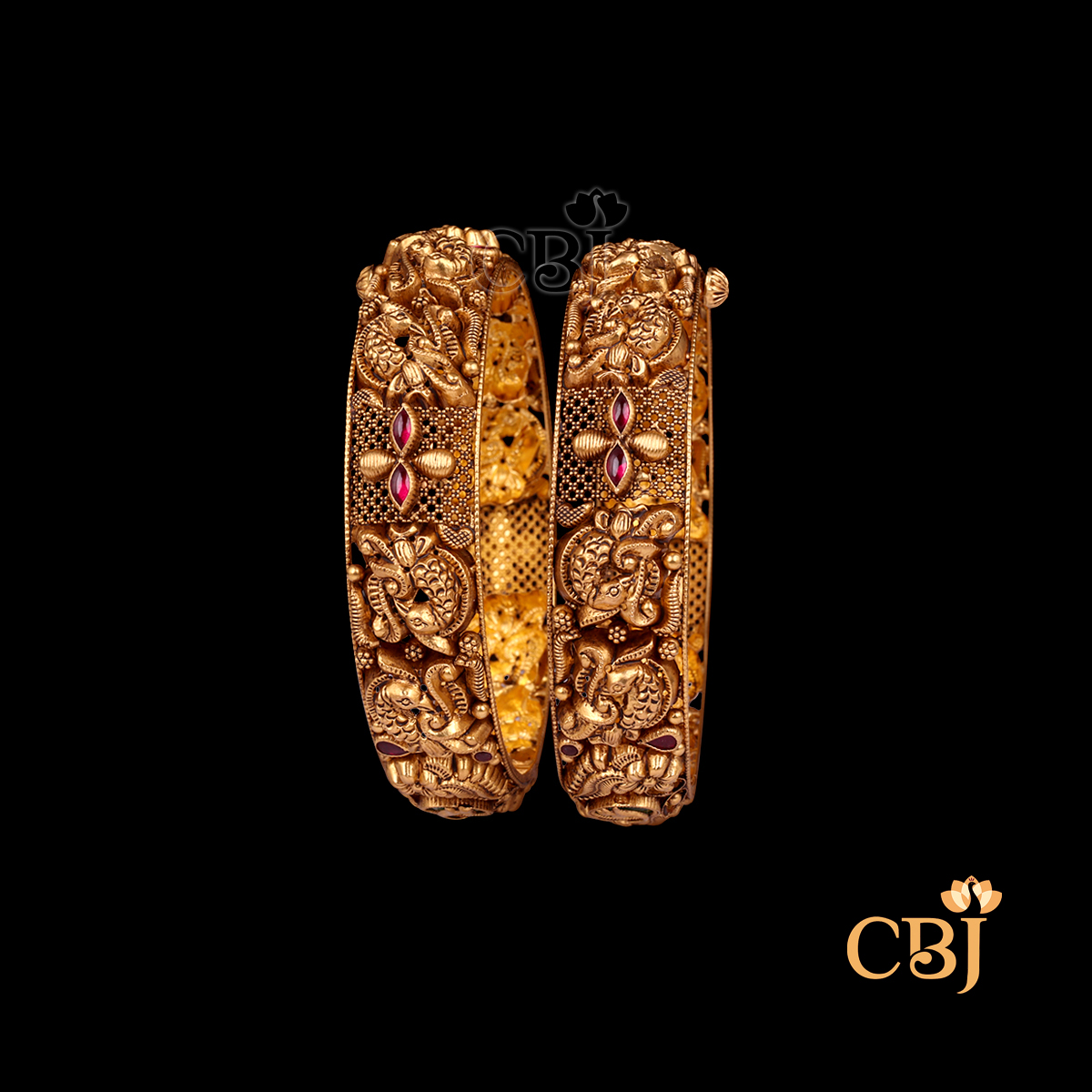 36 grams Nakshi Antique Bangles displayed as a pair of gold bangles with detailed Nakshi carvings