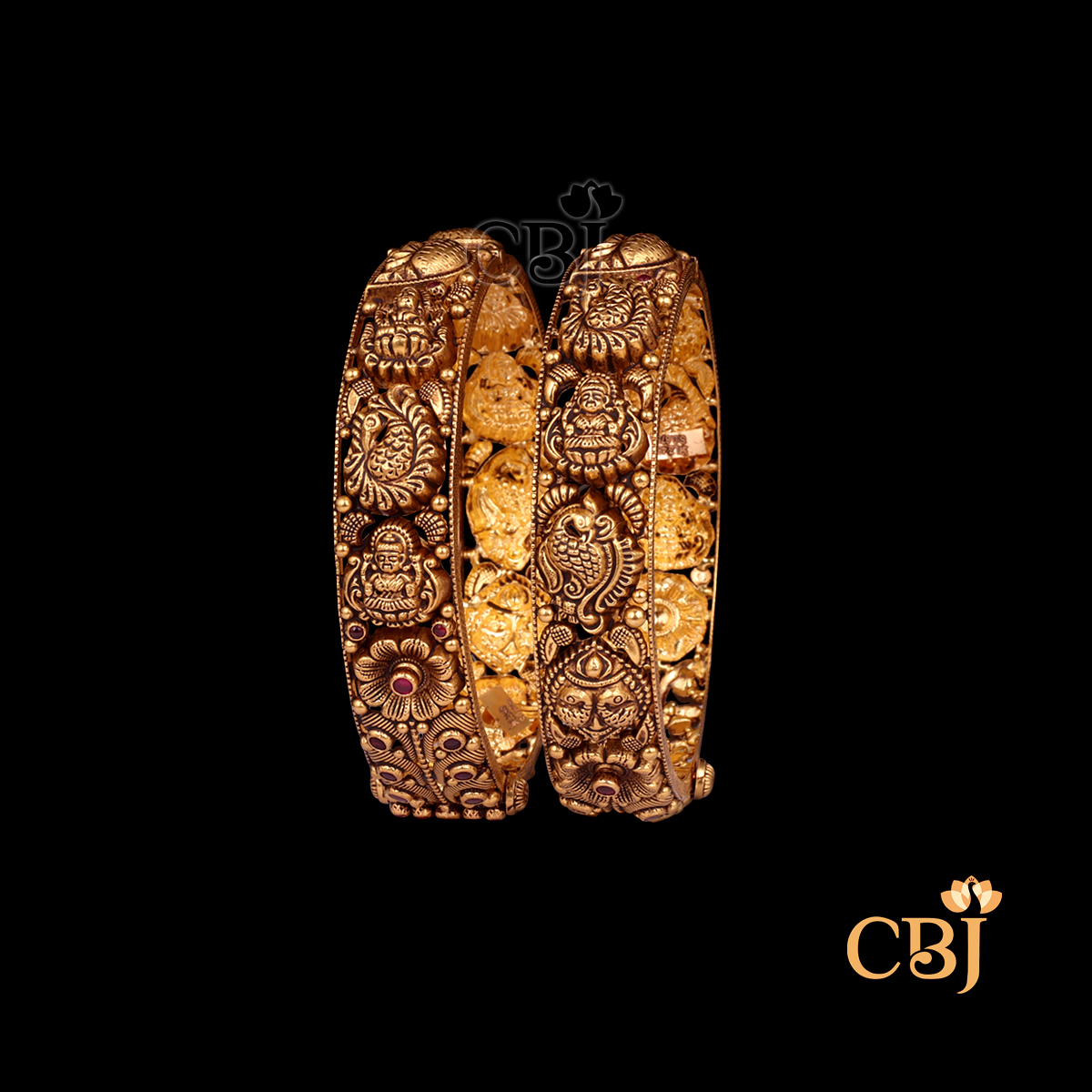 38 grams Nakshi Antique Bangles displayed as a pair of gold bangles with carved Nakshi detailing