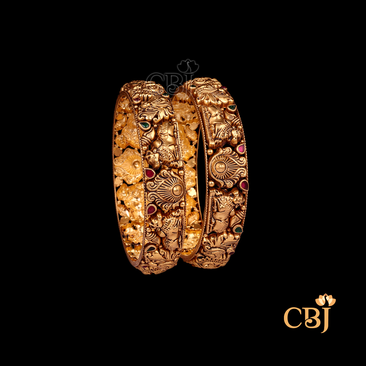 29 grams Nakshi Antique Bangles displayed as a pair of gold bangles with carved Nakshi patterns