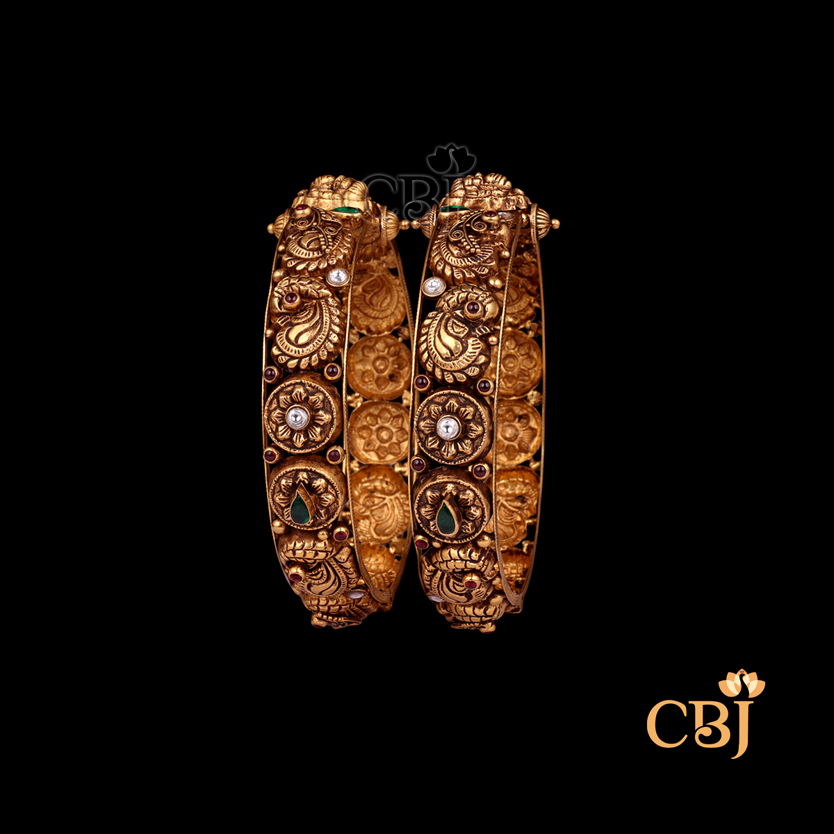 37 grams Nakshi Antique Bangles shown as a pair of gold bangles with carved Nakshi detailing
